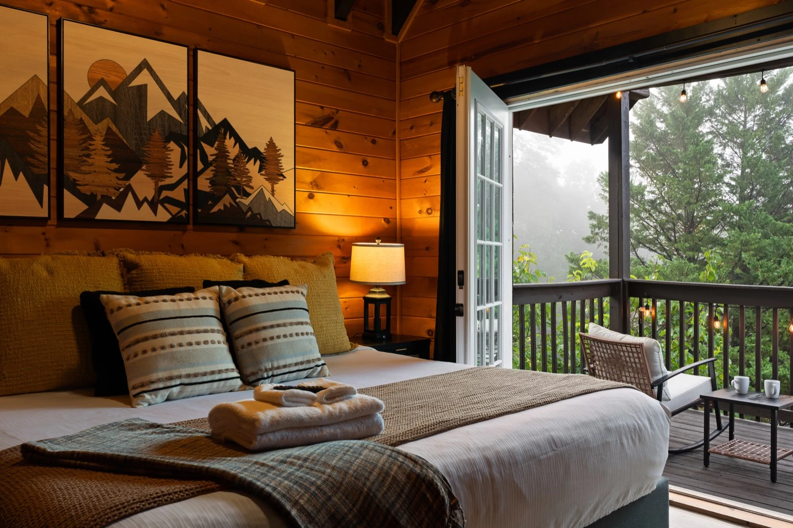 Primary bedroom with king bed and open doors to its private balcony
